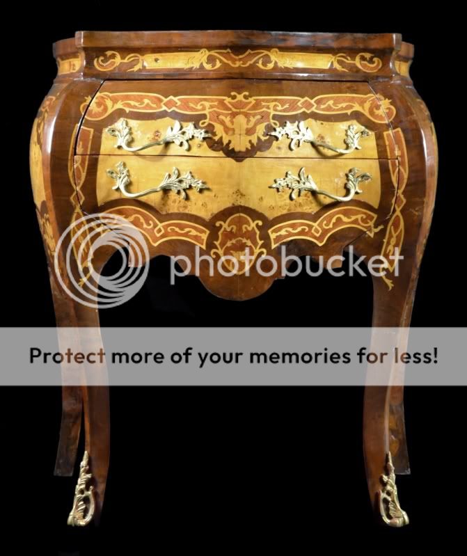   is a vintage chest of drawers covered in inlay veneer this piece is in